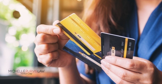 Woman holding credit cards.