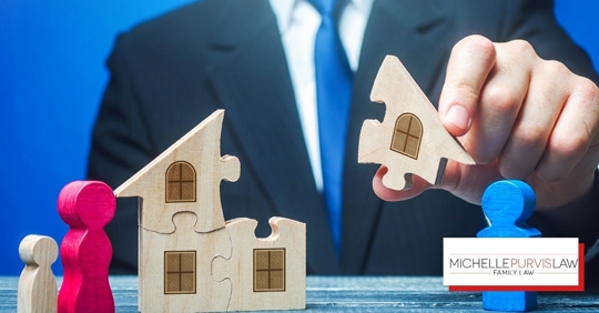 Man with suit on holding piece of house puzzle with person figurines.