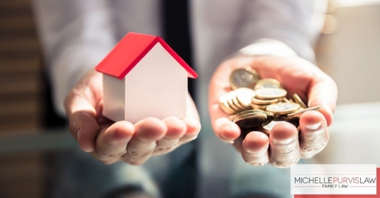 Woman holding change and house.
